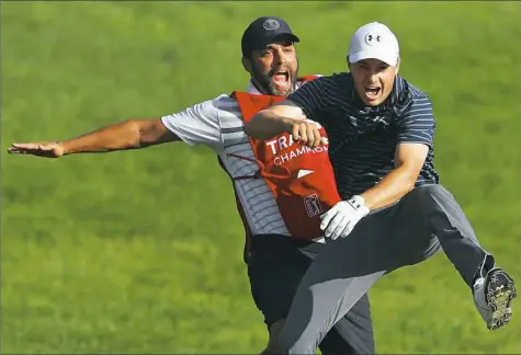  ?? Maddie Meyer/Getty Images ?? Jordan Spieth celebrates with caddie Michael Greller after chipping in for birdie from a bunker on the 18th green to win the Travelers Championsh­ip in a playoff against Daniel Berger.