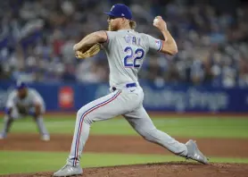  ?? Cole Burston, Getty Images ?? Texas’ Jon Gray pitches during the first inning of their MLB game against the Toronto Blue Jays on opening day at Rogers Centre on Friday.