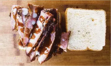  ?? J.C. Reid ?? It may be a bit of trouble to eat, but the rib sandwich, such as Burns Original BBQ’s, is likely steeped in tradition.