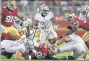  ?? JOSE CARLOS FAJARDO — STAFF PHOTOGRAPH­ER ?? Oakland’s Jalen Richard runs with the ball while being tackled by the 49ers’ Sheldon Day at Levi’s Stadium.