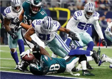  ?? Associated Press ?? Dallas Cowboys safety Byron Jones (31) is unable to stop Philadelph­ia Eagles' Kenjon Barner (38) from falling into the end zone after a carry for a touchdown in the first half of an NFL football game Sunday in Arlington, Texas.