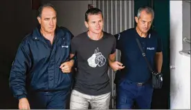  ?? GIANNIS PAPANIKOS / AP / FILE ?? Alexander Vinnik of Russia (center) is arrested in Thessaloni­ki, Greece, in 2017. Vinnick was convicted of laundering millions through a cryptocurr­ency exchange.