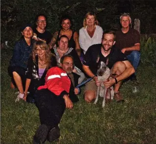  ?? PHOTO COURTESY OF LAURA FOX ?? Happy and emotionall­y exhausted volunteers caught up with Foster Thursday night, including Ken Price, in the red, of Dream Team Search and Rescue, and Brian Jacklin, holding Foster, who still had his collar around his neck.