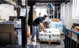  ?? ALEX ATACK/THE NEW YORK TIMES ?? Bags of flour are loaded onto a pallet May 15 at Wessex Mill in Wantage, England.