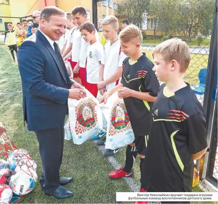  ??  ?? Виктор Николайкин вручает подарки игрокам футбольных команд воспитанни­ков детского дома.