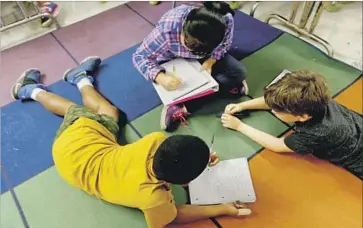  ?? Francine Orr Los Angeles Times ?? THE STATE’S new ratings system to assess public schools is color coded, grades on a curve and emphasizes progress in test scores. Above, students in the gifted magnet program at Eagle Rock Elementary School.