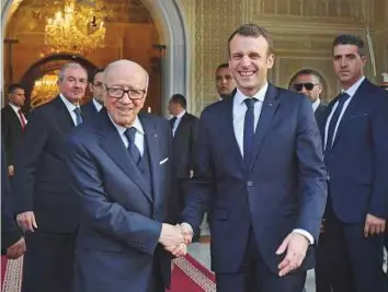  ?? AP ?? Tunisian President Beji Qaid Al Sebsi (left) welcomes French President Emmanuel Macron at the Presidenti­al Palace in Carthage, Tunisia, on Wednesday.