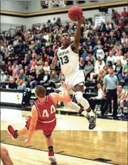  ?? TIM GODBEE / For the Calhoun Times ?? Calhoun’s Malik Lawrence (right) attempts a lay-up over Sonoravill­e’s Brad Wilson.