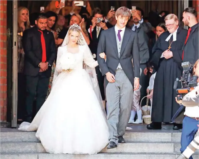  ?? — AFP ?? Ekaterina of Hanover and Prince Ernst August of Hanover leave after their church wedding ceremony in Hanover, central Germany.