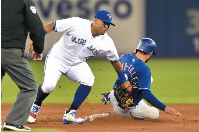  ?? CP PHOTO ?? Texas Rangers shortstop Isiah Kiner-Falefa gets caught trying to steal second base against Yangervis Solarte and the Toronto Blue Jays on Friday night in Toronto.