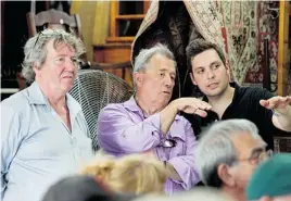  ??  ?? Antique specialist­s François Saint-Georges, left, Ken Meany, middle, and antique picker Beau Kavanaugh attend an auction at Sylvain Gélineau Encanteur in St-Hyacinthe.