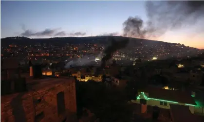  ?? Photograph: Anadolu Agency/Getty Images ?? Smoke rises during the clash at a house in Nablus, in the West Bank.