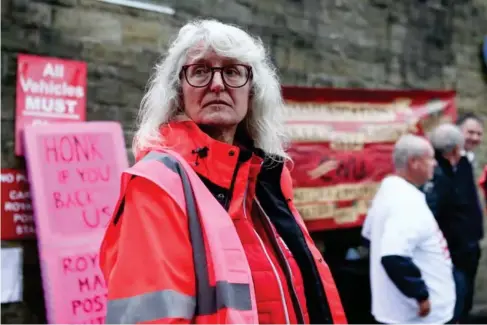  ?? (EPA) ?? A picket l ine outside a de l ivery office in Ho l mfirth, West Yorkshire