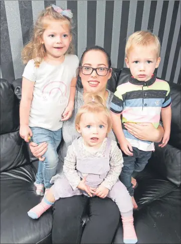  ??  ?? Picture Chris Austin Michaela Hotchkiss at home with her children, from left, Carly, Halle and Tommy