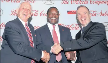 ?? PHOTO: SIMPHIWE MBOKAZI ?? SABMiller together with Coca-Cola combine to make a new company called Coca-Cola Beverages Africa. From left, its chairman Phil Gutsche; Nathan Kalumbu, president of Coca-Cola Eurasia and Africa; and SABMiller Africa’s Mark Bowman shake hands after the...