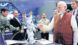  ?? ANI ?? Defence minister Rajnath Singh holds a light machine gun at the DRDO Pavilion and (right) Prime Minister Narendra Modi visits a stall during the inaugurati­on of ‘Defence Expo 2020’, in Lucknow on Wednesday.