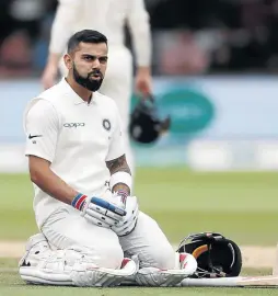  ?? / PAU L C H I L D S / R E U T E R S ?? India’s Virat Kohli reacts before receiving treatment from medical staff for a back injury.