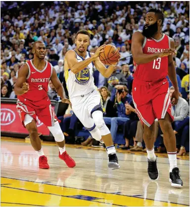  ?? EZRA SHAW / GETTY IMAGES ?? Warriors guard Steph Curry, here driving against the Rockets’ James Harden (13) and Chris Paul earlier this season, could miss Golden State’s first-round series with San Antonio because of an injured knee.