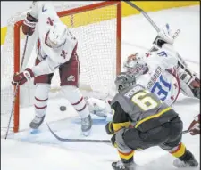  ?? Joe Mahoney The Associated Press ?? Max Pacioretty pokes in his own rebound before Colorado goaltender Philipp Grubauer can recover and as defenseman Devon Toews breaks his stick. The goal lifted the Knights to a 3-2 overtime win, giving them a split of their two games in Denver.