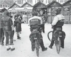  ?? SCOTT OLSON, GETTY IMAGES ?? Police patrol at Christkind­lmarket Chicago, a Germanthem­ed Christmas market, on Tuesday in the city’s downtown area. Chicago police increased patrols in and around the market after Monday’s terror attack in Berlin.