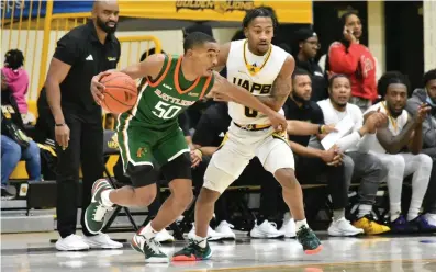  ?? (Pine Bluff Commercial/I.C. Murrell) ?? Trejon Ware of UAPB defends against Jalen Speer of Florida A&M as UAPB Coach Solomon Bozeman looks on in the first half Saturday at H.O. Clemmons Arena.