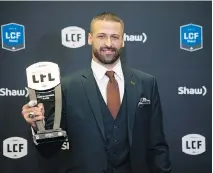  ?? NATHAN DENETTE/THE CANADIAN PRESS ?? The Edmonton Eskimos’ Mike Reilly displays his most outstandin­g player award in Ottawa on Thursday.