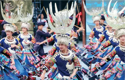  ??  ?? Dancers of the Miao ethnic group perform in Xijiang Qianhu Miao Village in Leishan County, Guizhou Province in southwest China, on August 2, 2019