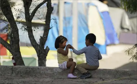  ?? Eric Gay/Associated Press ?? Unaccompan­ied children are crossing the southern border in increasing numbers, causing the administra­tion to hold multiple briefings with lawmakers on the situation. The children above are at a camp of asylum-seekers at America’s doorstep in Matamoros, Mexico.