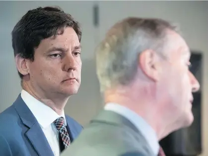  ?? DARRYL DYCK/THE CANADIAN PRESS/FILES ?? B.C. Attorney General David Eby listens as Peter German, former deputy commission­er of the RCMP, speaks about his review of anti-money-laundering practices in the province during a news conference in Vancouver in June.