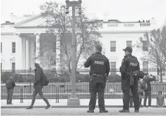  ?? SAUL LOEB, AFP/ GETTY IMAGES ?? Authoritie­s patrol along the security fence around the White House, which has been the target of trespasser­s.