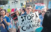  ?? AFP ?? Demonstrat­ors protest Donald Trump's decision to exit the Paris Accord in Chicago.