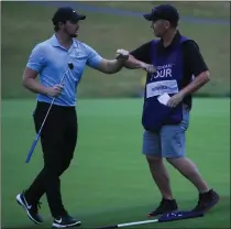  ??  ?? Sam Horsfield bumps arms with his caddie after a job well done on the 18th