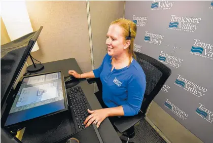  ?? STAFF PHOTOS BY TIM BARBER ?? TVFCU’s first remote bank teller, Anneliese Pierce, talks with a customer as a remote personal teller inside the TVFCU LIVE Studio on Chestnut Street.