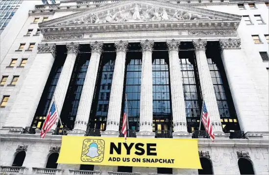  ?? Astrid Stawiarz Getty Images ?? A SNAPCHAT BANNER hangs outside the New York Stock Exchange in November. The app’s parent, Snap, is on track for an initial public offering next month.