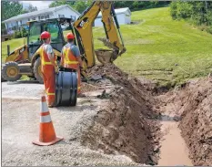  ?? PHOTO BY COLIN CHISHOLM ?? Department of transporta­tion and infrastruc­ture renewal crews work on fixing a culvert on Williams Road in Ellershous­e a week after flash flooding that on Aug. 7.