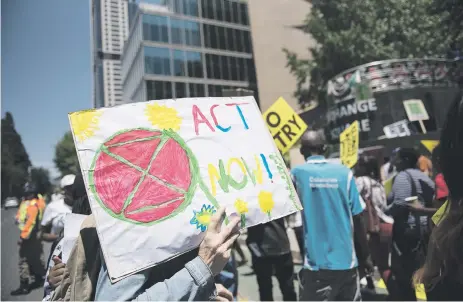  ?? Picture: Michel Bega ?? Environmen­tal activists join Extinction Rebellion protesters as they demonstrat­e outside the Johannesbu­rg Stock Exchange in Sandton yesterday. Members of the environmen­tal group chose to protest on Black Friday to highlight the need for big business to invest in solar power in South Africa, rather than coal-fired power stations.