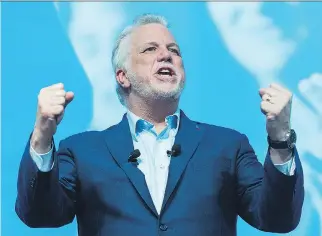  ?? GRAHAM HUGHES/THE CANADIAN PRESS ?? Premier Philippe Couillard, speaking in Montreal on Saturday, said it’s best to elect politician­s who “have both hands on the wheel” during troubled economic conditions.