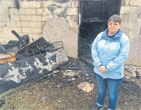  ??  ?? Susan Vines of Leslie Golf Club’s management team beside the burned-out lock-up following the deliberate blaze at the weekend.