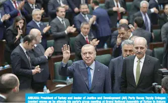  ??  ?? ANKARA: President of Turkey and leader of Justice and Developmen­t (AK) Party Recep Tayyip Erdogan (center) waves as he attends his party’s group meeting at Grand National Assembly of Turkey in Ankara yesterday. —AFP