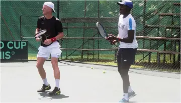  ?? II ?? SWEATING IT OUT . . . Members of the Zimbabwe Davis Cup tennis team Courtney Loc k(left)and Benedict Badza play a doubles match at Harare Sports Club as they prepare for their World Group Play-off tie against Uruguay. The two-day tie gets underway on Friday at the same venue. — Photo by Nomxolisi Museta