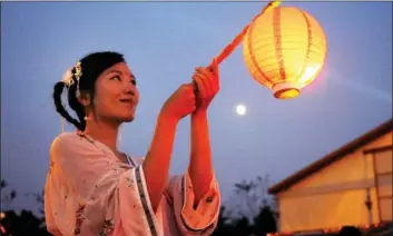  ?? PHOTOS BY YANG YI, ZENG LINGHUA AND LIN KEGENG / FOR CHINA DAILY ?? From Left: A young woman clad in a traditiona­l dress takes part in a festival celebratio­n in Sh ceremony in Fuzhou, Fujian province.