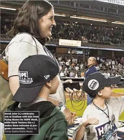  ??  ?? Derek Jeter (r.) celebrates win at Stadium with kids from Flying Manes for HOPE Week, while Mark Teixiera (far r.) makes them welcome at pregame ceremonies.
Photo by Corey Sipkin/Daily News