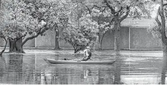  ?? Jon Shapley / Houston Chronicle file ?? A kayaker pauses for water along Wigton Drive in the Meyerland area in April 2016.