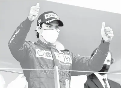  ?? — Gambar AFP ?? KOMITED: Gambar fail bertarikh 23 Mei 2021 ini menunjukka­n Leclerc meraikan kejayaanny­a di atas podium selepas dengan memenangi tempat kedua pada perlumbaan Formula 1 Grand Prix Monaco.