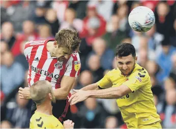  ??  ?? Glenn Loovens wins a header at the Stadium of Light on Saturday.