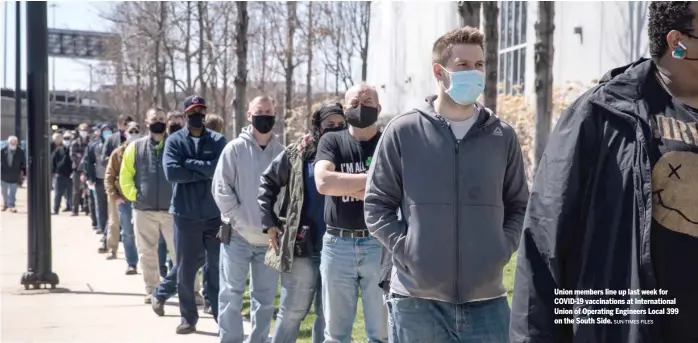  ?? SUN-TIMES FILES ?? Union members line up last week for COVID-19 vaccinatio­ns at Internatio­nal Union of Operating Engineers Local 399 on the South Side.