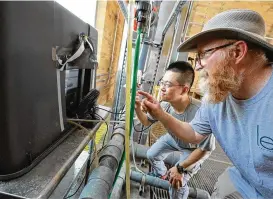  ?? UNIVERSITY OF TOLEDO ?? University of Toledo Lake Erie Center Director Tom Bridgeman and Kuo-pei Tsai, a postdoctor­al research associate, read data generated by the device.