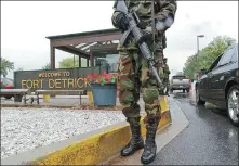 ?? OLIVIER DOULIERY / AGENCE FRANCE-PRESSE ?? Military personnel stand guard outside the US Army Medical Research Institute of Infectious Diseases at Fort Detrick in 2002.