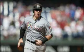  ?? LAURENCE KESTERSON — THE ASSOCIATED PRESS ?? First baseman Justin Bour, here after hitting a home run against the Phillies last week, will likely be used as a power-hitting pinch-hitter with Carlos Santana locked in as the starting first baseman.