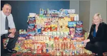  ?? Photo: KRIS DANDO ?? Grocery generosity: Porirua Club executive member John Rowe and general manager Lisa Beighton with the groceries collected in June.